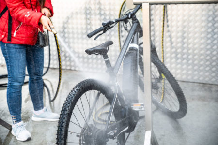 Woman cleaning bike with eraser sponge