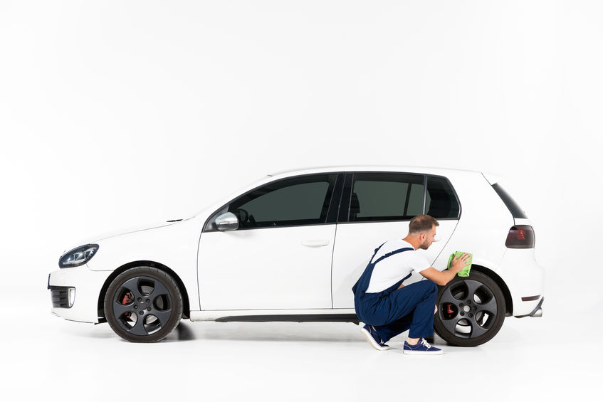 Man scrubbing car with monster scrubby sponge