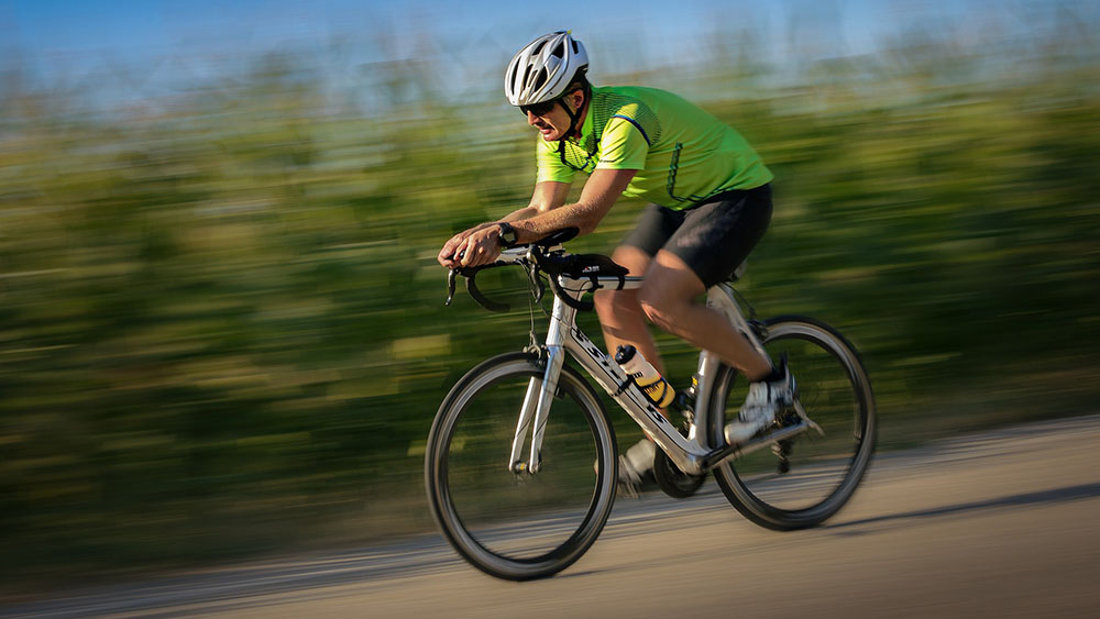 cyclist riding bicycle - How to Clean a Bike