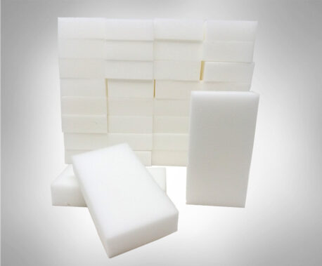 A stack of melamine foam eraser sponges with two eraser sponges in front to show length. Sponge Outlet bulk eraser sponges.