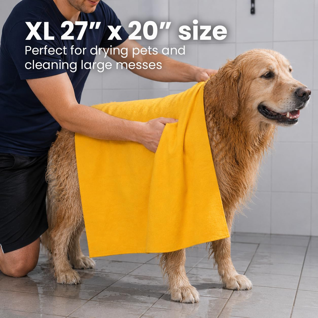 Dog owner drying a wet golden retriever with a soft absorbent shammy chamois towel after a bath or outdoor activity. There is text overlayed on the image which reads "XL 27" x 20" size is perfect for drying pets and cleaning large messes"